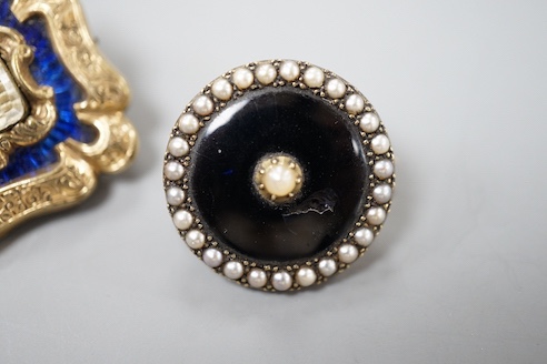 A Victorian yellow metal overlaid and blue enamel set mourning brooch, 31mm and one other seed pearl set mourning brooch.